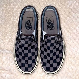 Classic checkerboard slip-on shoes. Vans. Black and gray.